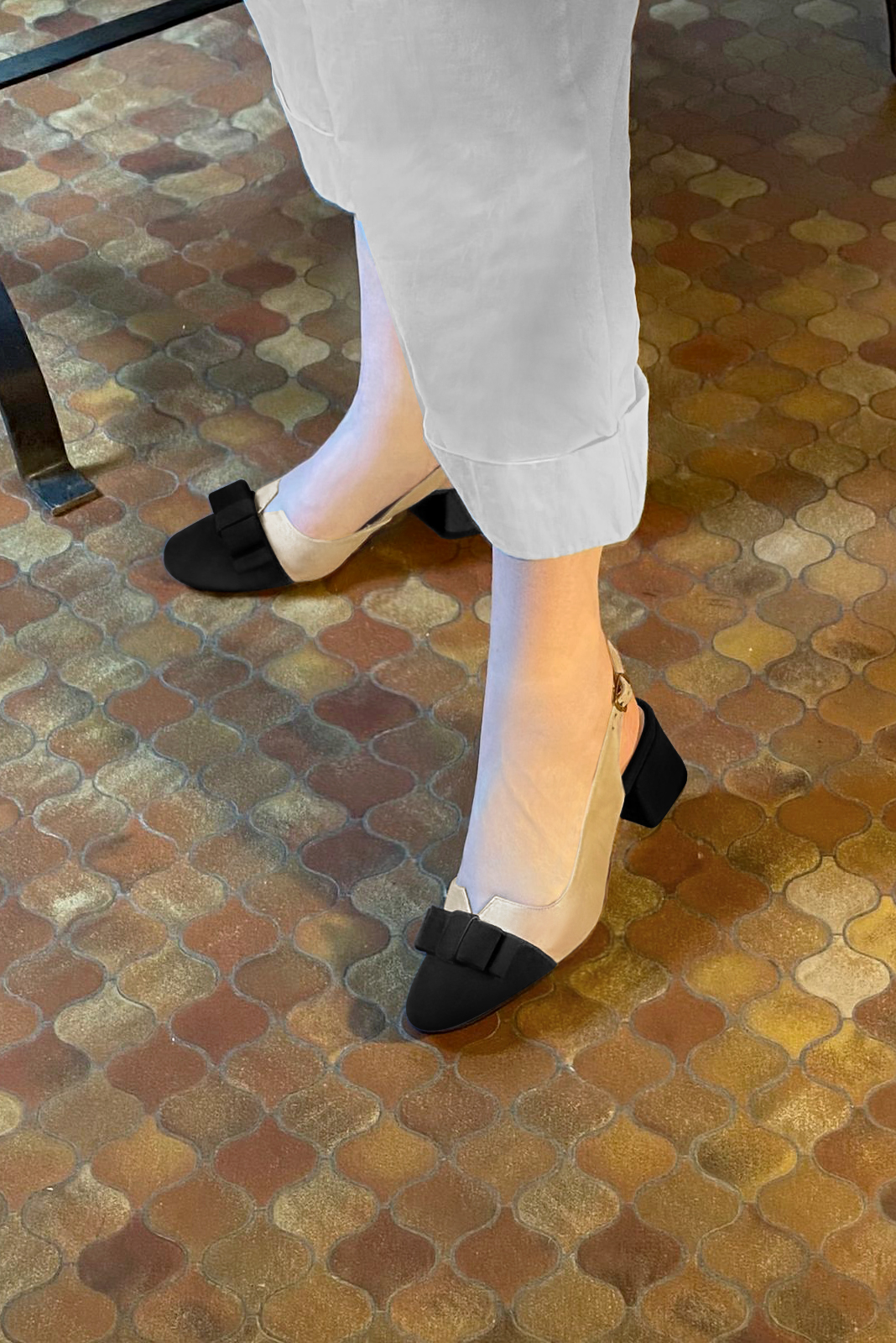 Matt black and gold women's open back shoes, with a knot. Round toe. Low flare heels. Worn view - Florence KOOIJMAN
